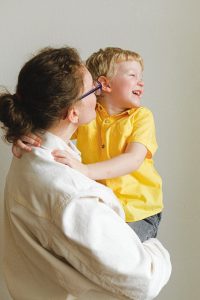 Northfield Parenting Plan Lawyer woman carrying boy wearing yellow polo shirt 3905790 200x300